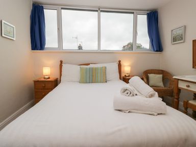 A bedroom with a bed and lamp at Cloud Cottage in Ambleside