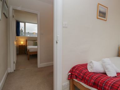 A bedroom with a bed and a window at Cloud Cottage Ambleside