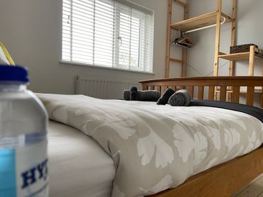A bedroom with a bed and a shelf at Dolwen in Caernarfon