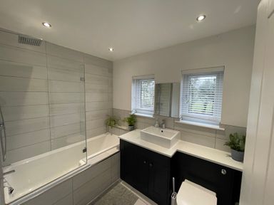 A bathroom with a bathtub and sink at Dolwen in Caernarfon