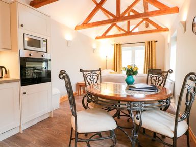 A dining room with a table and chairs at The Old Sorting Office