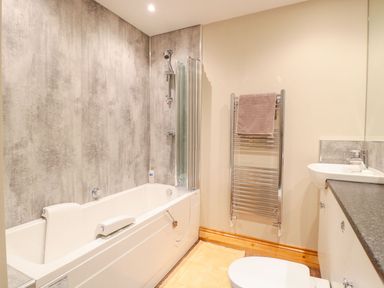 A bathroom with a bathtub and sink at The Old Sorting Office
