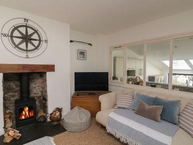 A living room with a fireplace and sofa at 36 Crowthers Hill in Dartmouth