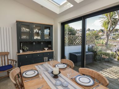 A dining room with a table set for a meal at 36 Crowthers Hill in Dartmouth