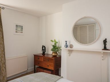 A bedroom with a dresser and mirror at 36 Crowthers Hill in Dartmouth
