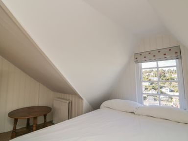 A bedroom with a bed and a table at 36 Crowthers Hill Dartmouth