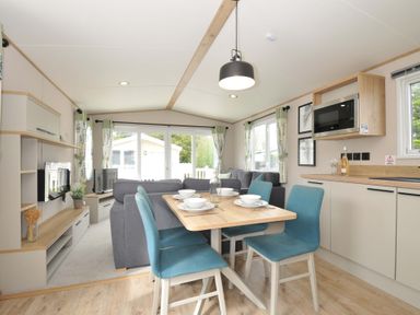 A dining area with a table and chairs at Eden Way 47