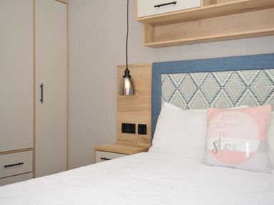 A bedroom with a bed and wardrobe at Eden Way 47