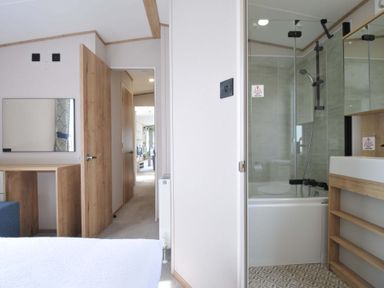 A bathroom with a shower, bathtub, and sink at Eden Way 47