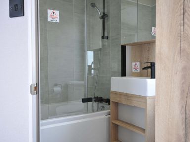 A bathroom with a shower and sink at Eden Way 47