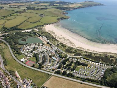An aerial view of a beach and caravan park at Par Sands Holiday Park - Par
