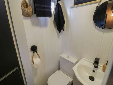 A bathroom with a toilet and sink at GiGi's Horsebox in Evesham