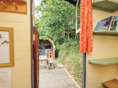 A view of an outdoor area with a table and benches at Goldfinch Panson Mill near Ashwater