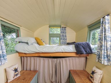 A bedroom with a loft bed and windows at Prudence in Panson Mill near Ashwater