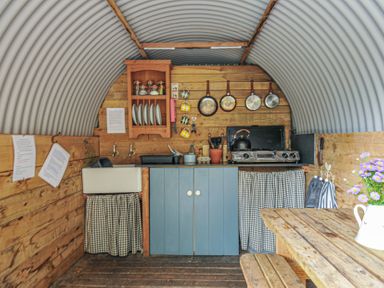 A kitchen with a cooking stove and sink at Prudence Panson Mill near Ashwater