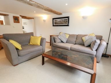 A living room with sofas and a coffee table at Bubbs Cottage