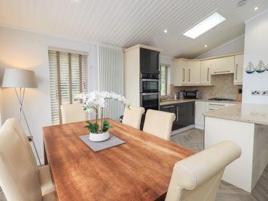 A dining room with a table and chairs at Laughing Duck in Troutbeck Bridge