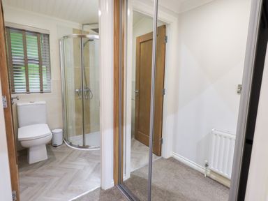 A bathroom with a shower and toilet at Laughing Duck in Troutbeck Bridge