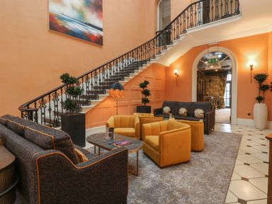 A lobby with a staircase and seating area at Costal Lodge at Seaham Hall Seaham