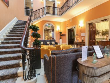 A lobby with a staircase and seating area at Costal Lodge at Seaham Hall Seaham