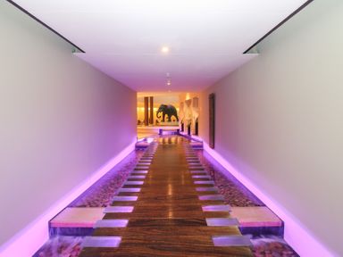 A hallway with a wooden walkway and a sculpture at Costal Lodge at Seaham Hall, Seaham