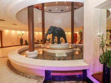 A lobby with an elephant statue and a fountain at Costal Lodge at Seaham Hall Seaham