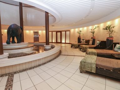 A lobby with an elephant statue and seating area at Coastal Lodge at Seaham Hall