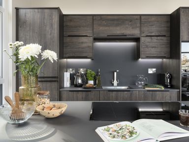 A kitchen with cabinets, sink, kettle, and a bowl with salad at Costal Lodge at Seaham Hall, Seaham