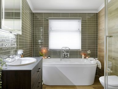 A bathroom with a bath tub, sink, and toilet at Costal Lodge at Seaham Hall in Seaham