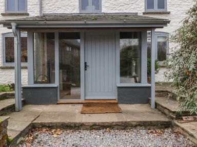 An entryway with a grey door and windows at 3 bed property