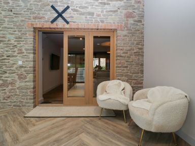 An entrance hall with double doors and two armchairs at 3 bed property
