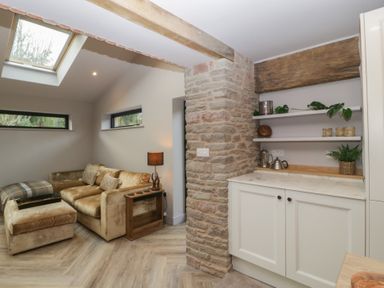 A living room with a sofa and shelving at 3 bed property