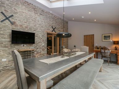 A dining area with a large table and chairs at 3 bed property