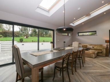 A dining room with a table and chairs at 3 bed property