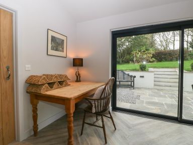 A dining room with a table and chair at a 3 bed property