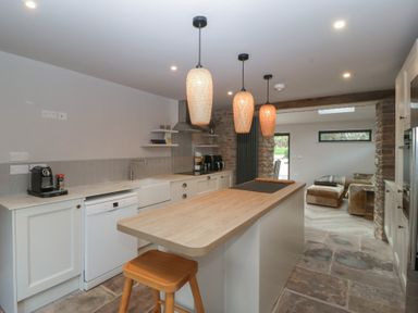 A kitchen with an island and appliances at a 3 bed property in 