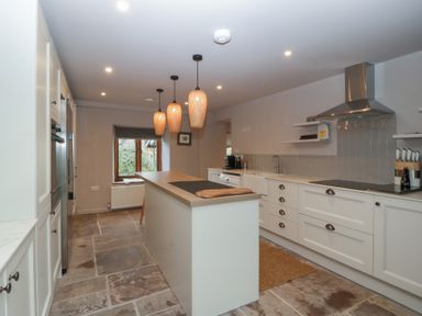 A kitchen with an island and appliances at 3 bed property