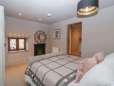 A bedroom with a bed and mirror at 3 bed property 