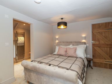 A bedroom with a bed and a towel radiator at 3 bed property