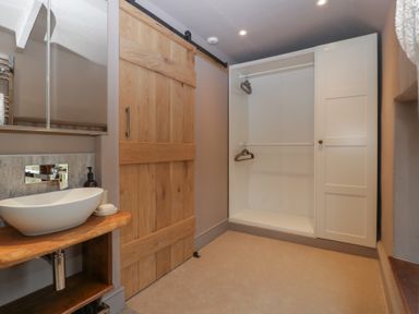 A bathroom with a sink and mirror at 3 bed property