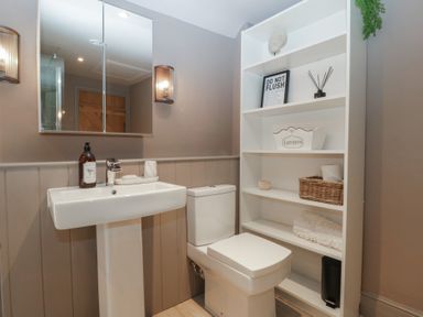 A bathroom with sink and toilet at 3 bed property