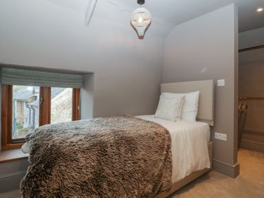 A bedroom with a bed and window at 3 bed property