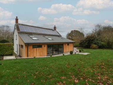 A house with solar panels and garden at a 3 bed property