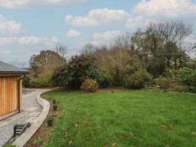A garden with grass and trees at a 3 bed property 