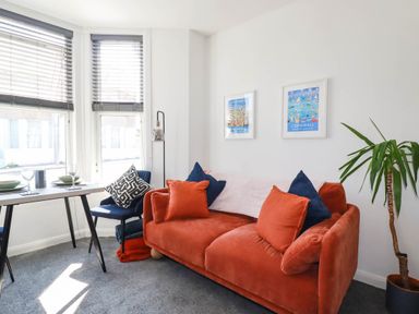 A living room with a sofa and a dining table at Higher Tower Road 