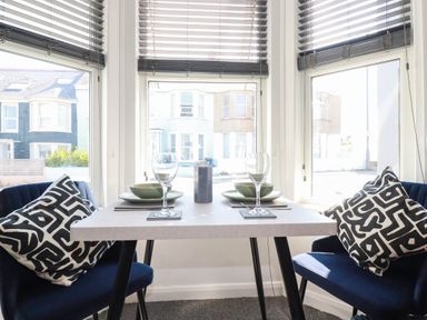 A dining room with a table set for two at Higher Tower Road