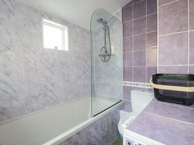A bathroom with a bathtub, shower, toilet and sink at Higher Tower Road