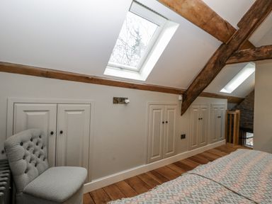 A bedroom with a skylight and cabinets at 1 bed property Usk