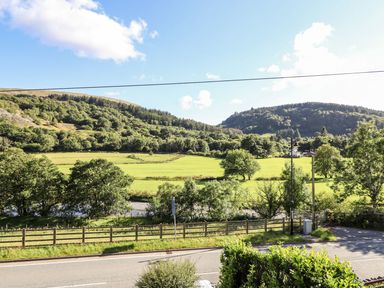 A view of fields and mountains at Haulfryn in Dolwyddelan