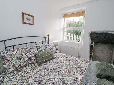 A bedroom with a bed and window at Haulfryn in Dolwyddelan